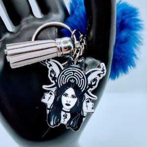 The Trio Acrylic Keychain With Fur And Tassel.